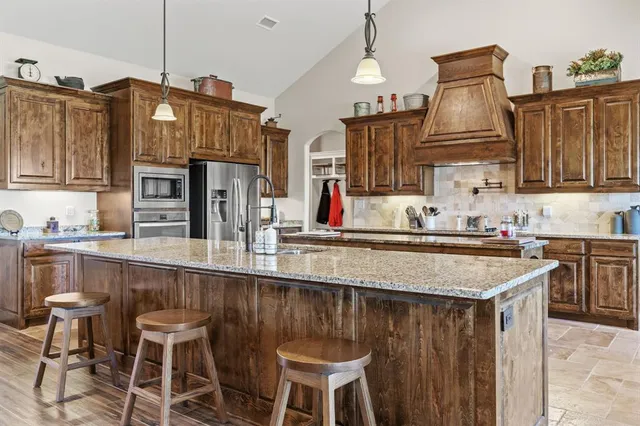 a kitchen with lots of counter top space and appliances