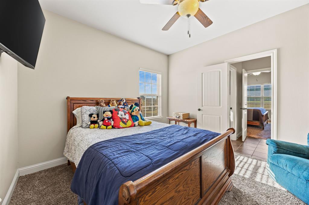 454 Farr Altom Road Seagoville, TX 75159 - Photo 23 of 29 a bedroom with a bed and a chandelier