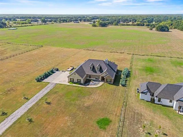 a front view of house with outdoor seating and green space