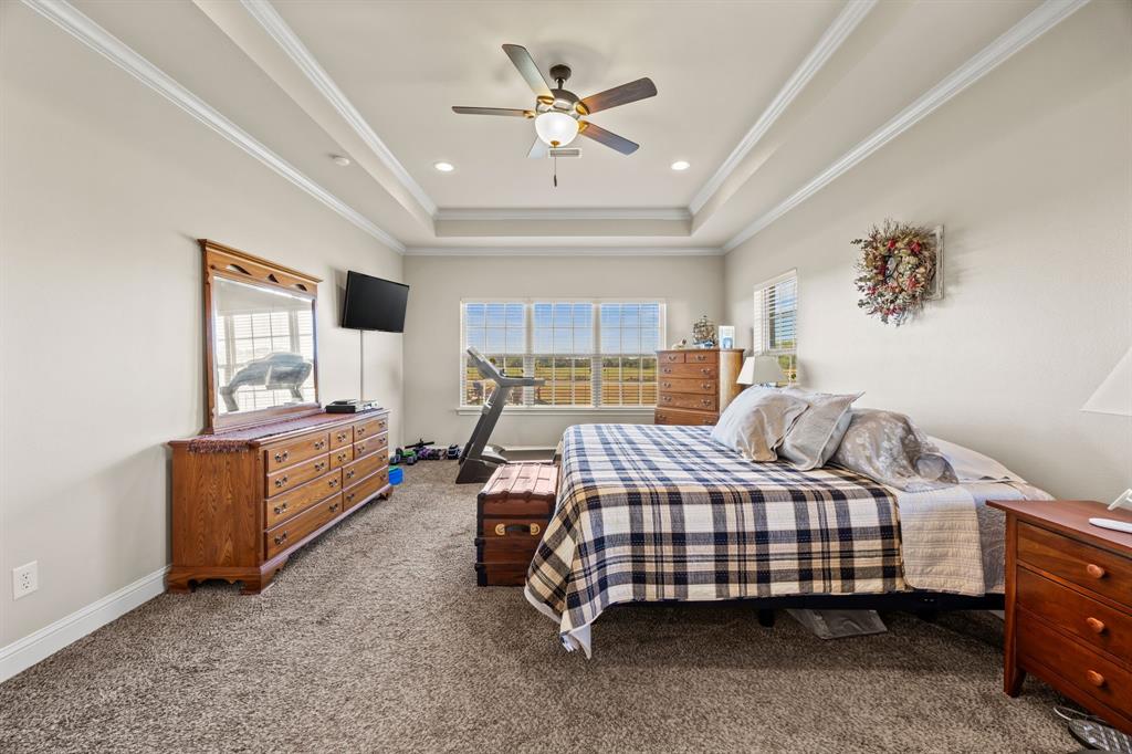 454 Farr Altom Road Seagoville, TX 75159 - Photo 8 of 29 a bedroom with a bed and a chandelier