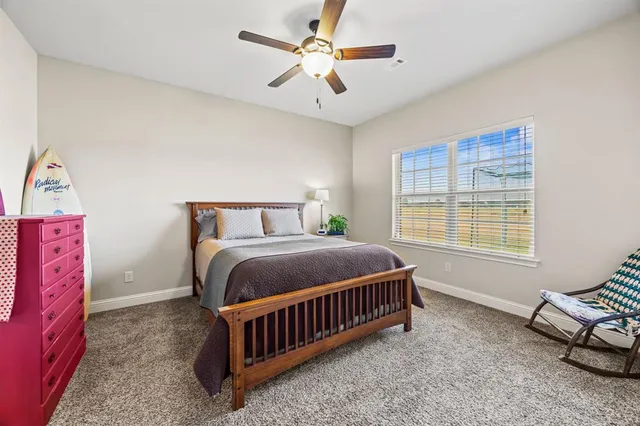 a bedroom with a bed a couch and a chandelier