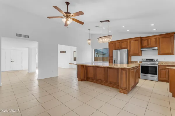 a large kitchen with stainless steel appliances a cabinets and counter space