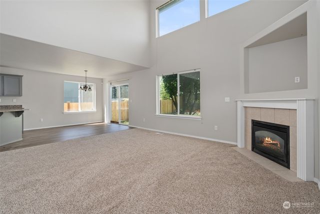 a view of empty room with a fireplace
