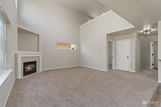 a view of an empty room with a fireplace