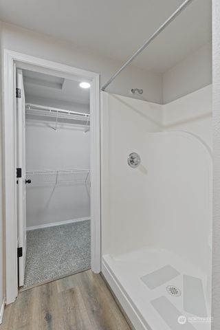 a bathroom with a glass shower door