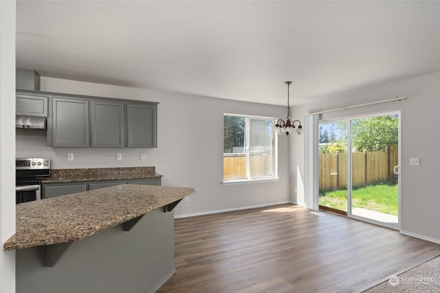 a kitchen with granite countertop a sink and a counter top space