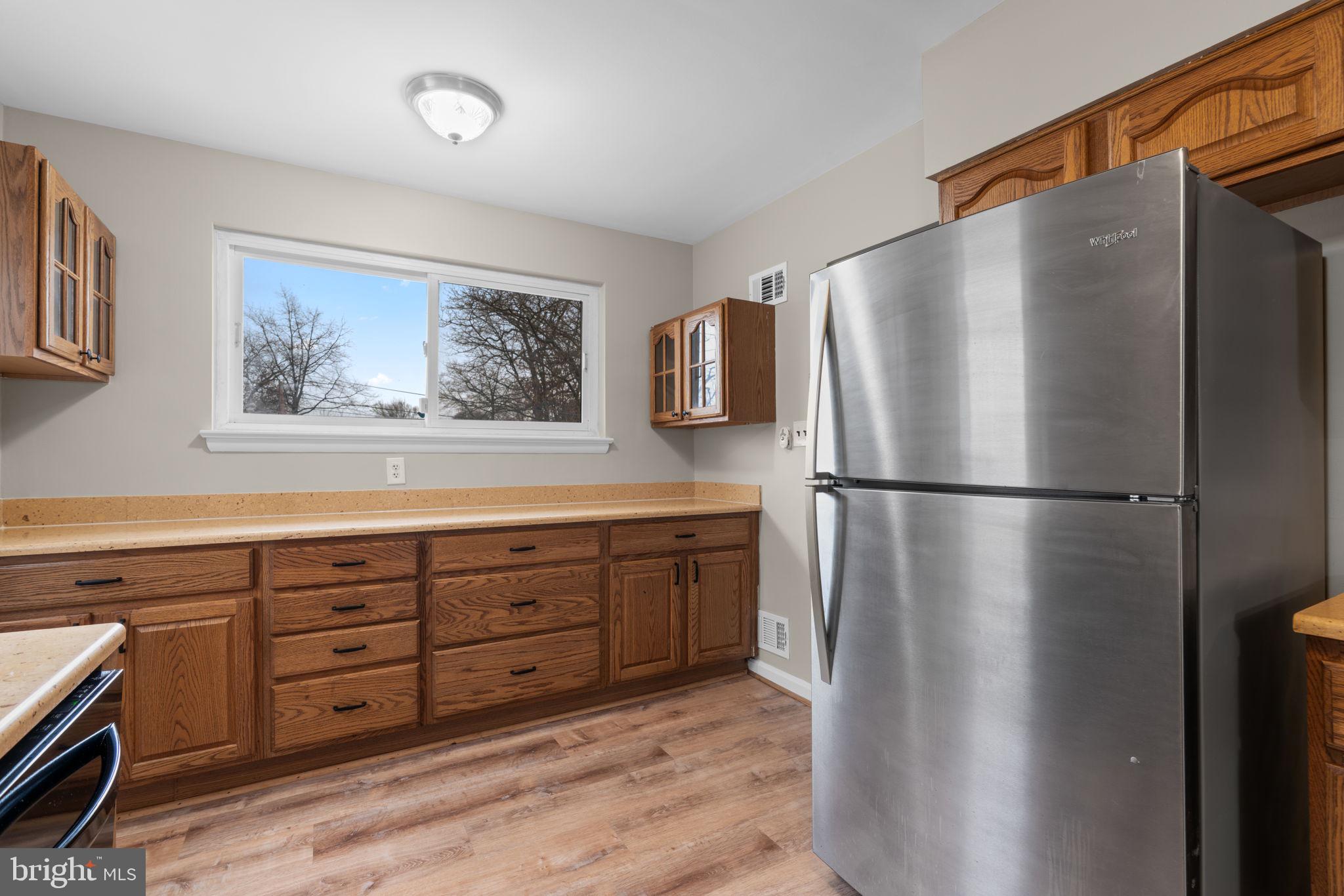 7514 Dundalk Road Takoma Park, MD 20912 - Photo 15 of 50 a kitchen with stainless steel appliances granite countertop a refrigerator and a stove top oven