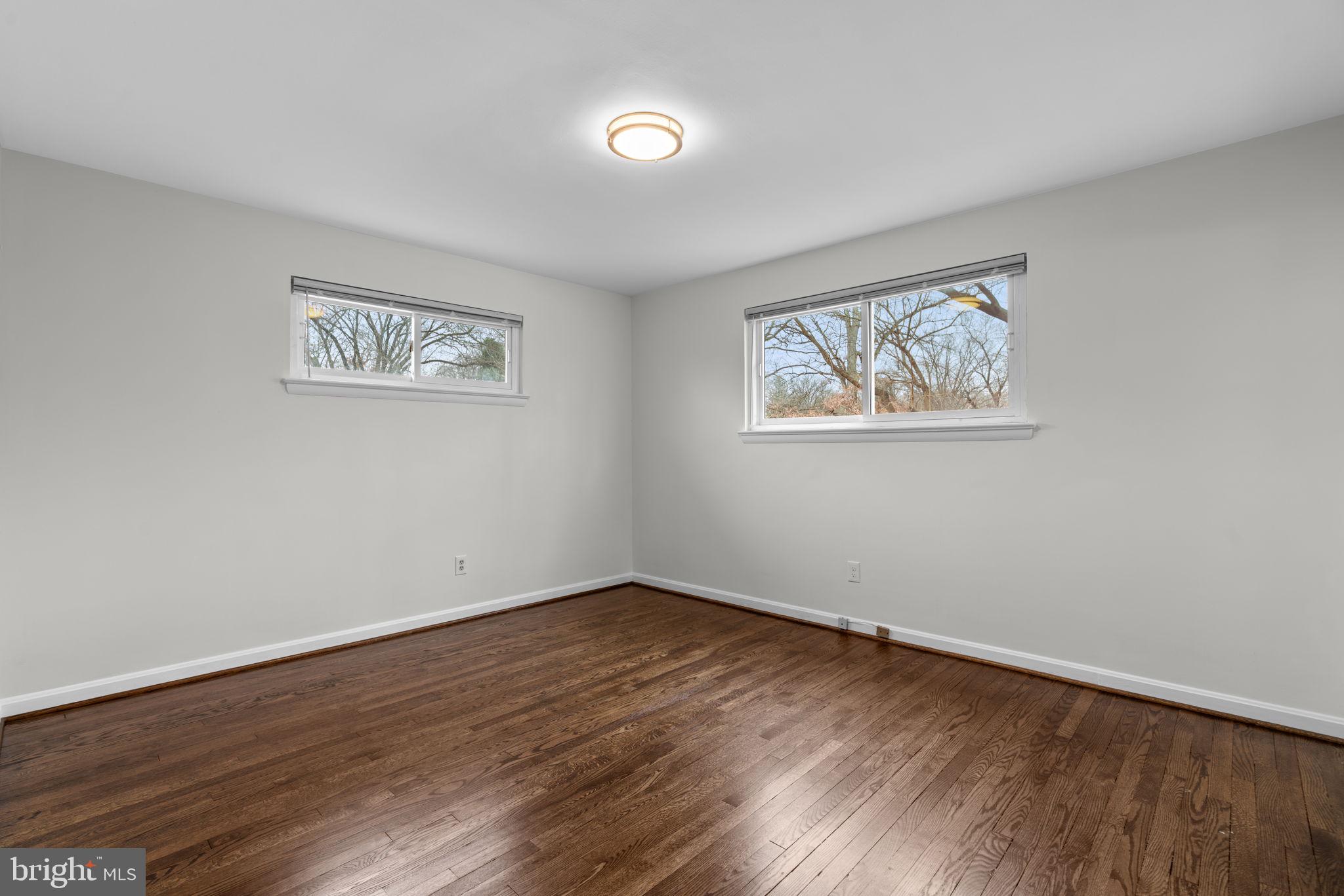 7514 Dundalk Road Takoma Park, MD 20912 - Photo 19 of 50 a view of an empty room with wooden floor and a window