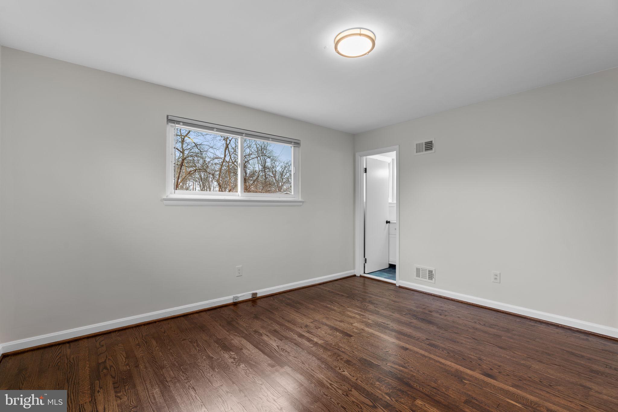 7514 Dundalk Road Takoma Park, MD 20912 - Photo 20 of 50 an empty room with wooden floor and windows