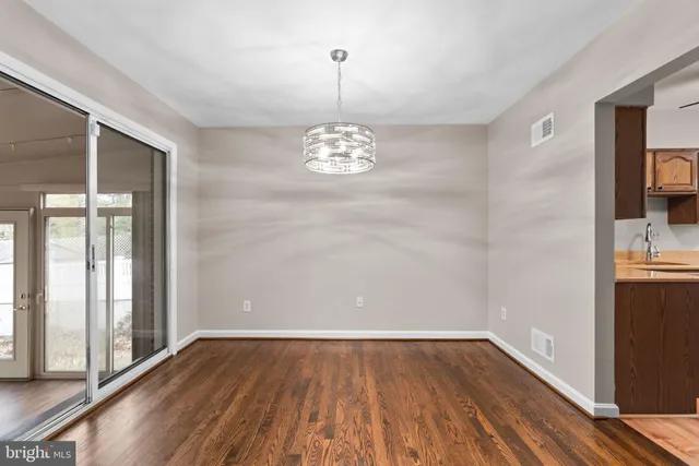 a view of a room with wooden floor and a window