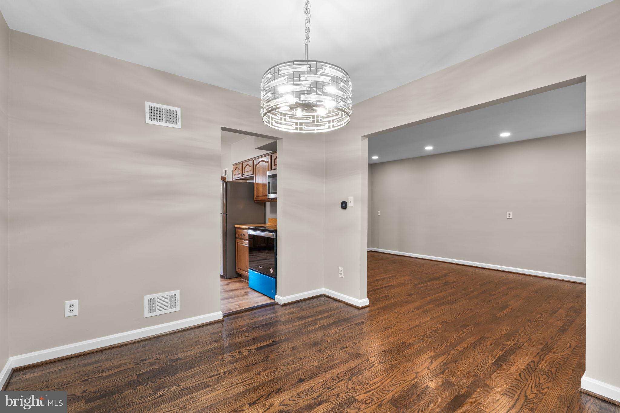 7514 Dundalk Road Takoma Park, MD 20912 - Photo 9 of 50 a view of an empty room with wooden floor and a window