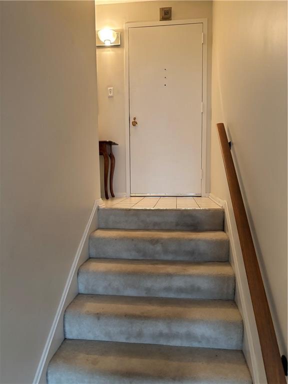 1160 Bower Hill Road, Unit 312B Mt. Lebanon, PA 15243 - Photo 11 of 13 a view of staircase with white walls and empty racks