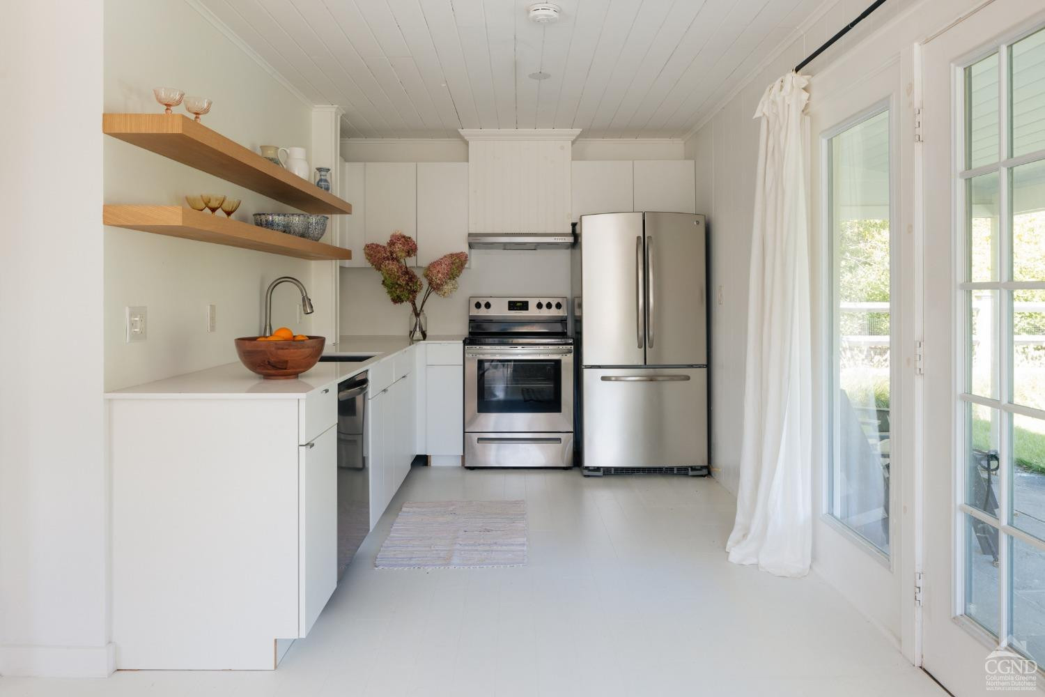 730 Ackert Hook Road Rhinebeck, NY 12572 - Photo 37 of 45 a kitchen with stainless steel appliances a refrigerator and a sink