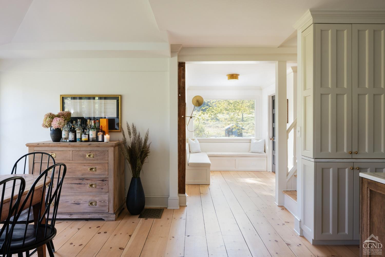 730 Ackert Hook Road Rhinebeck, NY 12572 - Photo 9 of 45 a view of a hallway to a livingroom with wooden floor and furniture