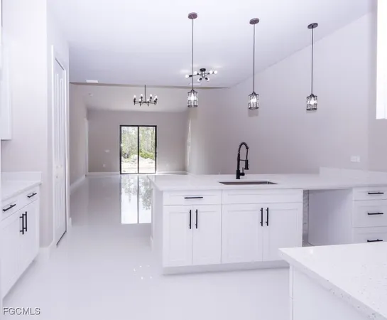 a kitchen with a sink and chandelier