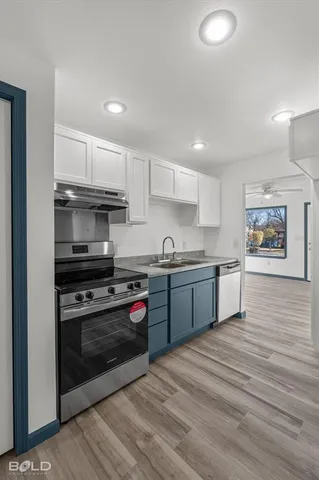 a kitchen with stainless steel appliances granite countertop a stove and a refrigerator