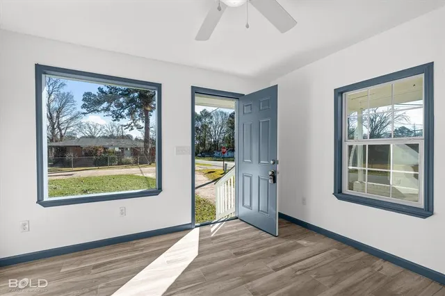 wooden floor in an empty room with a window