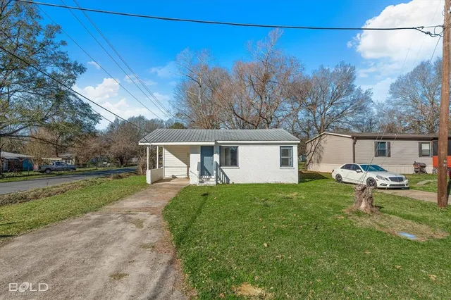 a view of a backyard with a garden and trees