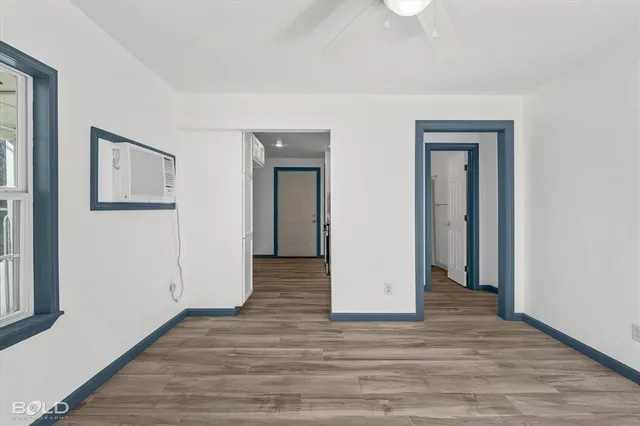 a view of hallway with wooden floor