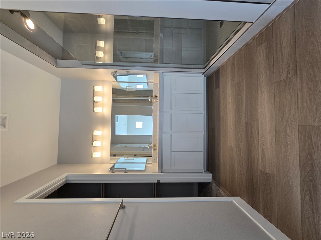 852 Weston Ridge Street Henderson, NV 89011 - Photo 16 of 28 A well-lit bathroom features a double vanity with ample storage and a modern glass shower.