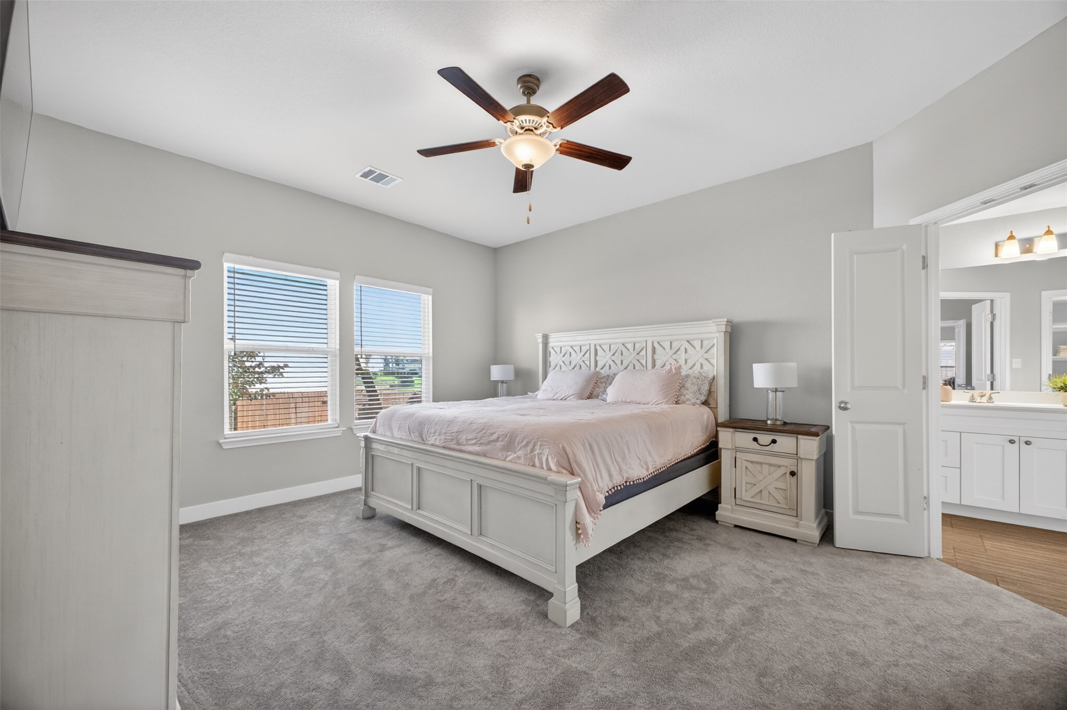 1009 Bright Star Cove Georgetown, TX 78628 - Photo 9 of 40 a bedroom with a large bed and a ceiling fan
