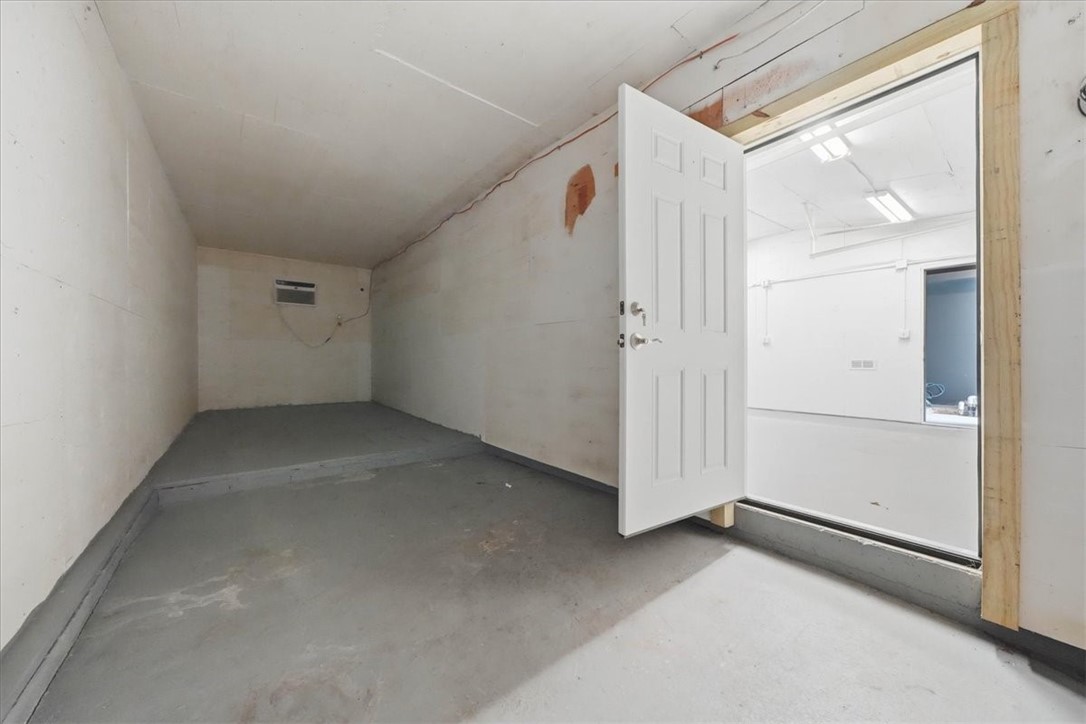 214 Anan Wade Road Glocester, RI 02857 - Photo 45 of 50 Beyond the detached garage is another separate, generously sized room, further expanding the building’s functionality. This additional space could continue serving as substantial storage or potentially be reimagined for a variety of uses.