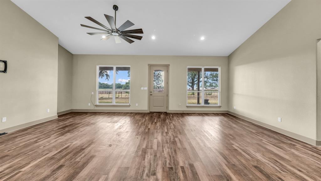 990 Doss Road Millsap, TX 76066 - Photo 17 of 40 wooden floor in an empty room with a window
