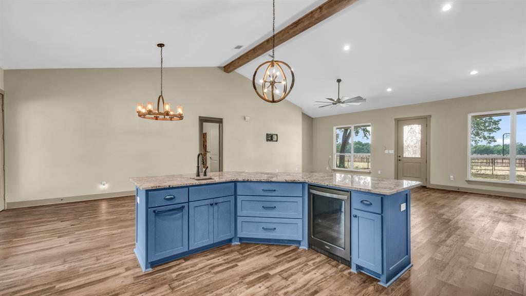 990 Doss Road Millsap, TX 76066 - Photo 40 of 40 a spacious bathroom with a granite countertop sink a toilet and a mirror
