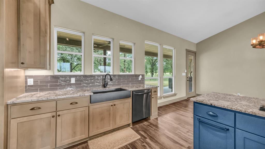990 Doss Road Millsap, TX 76066 - Photo 20 of 40 a kitchen with a sink stove and cabinets