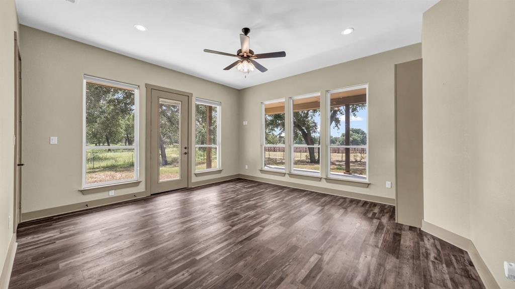 990 Doss Road Millsap, TX 76066 - Photo 26 of 40 a view of an empty room with a window and wooden floor
