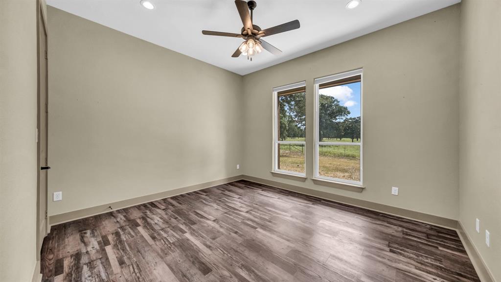 990 Doss Road Millsap, TX 76066 - Photo 28 of 40 wooden floor in an empty room with a window
