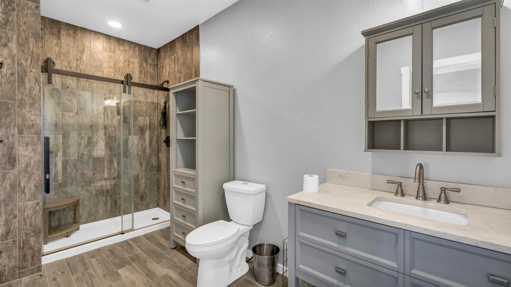 990 Doss Road Millsap, TX 76066 - Photo 32 of 40 a bathroom with a sink toilet and shower