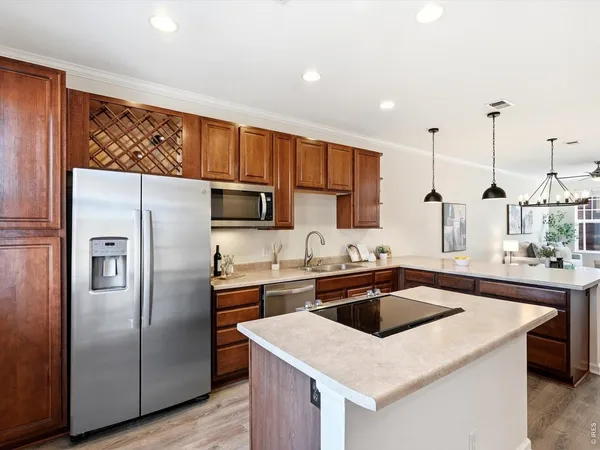 a kitchen with stainless steel appliances granite countertop a sink a stove and a refrigerator