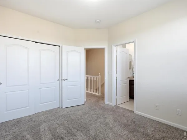 a bedroom with a bed and a painting