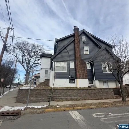 a front view of a house with a road