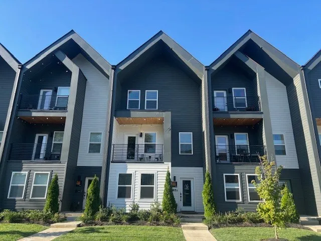 a front view of a residential apartment building with a yard