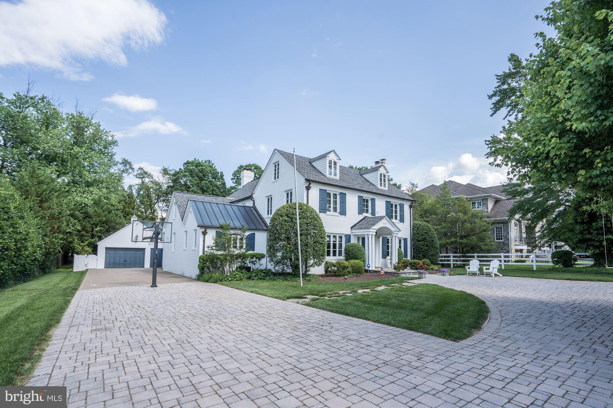 1319 Calder Road McLean, VA 22101 - Photo 2 of 55 a view of a white house next to a yard with big trees