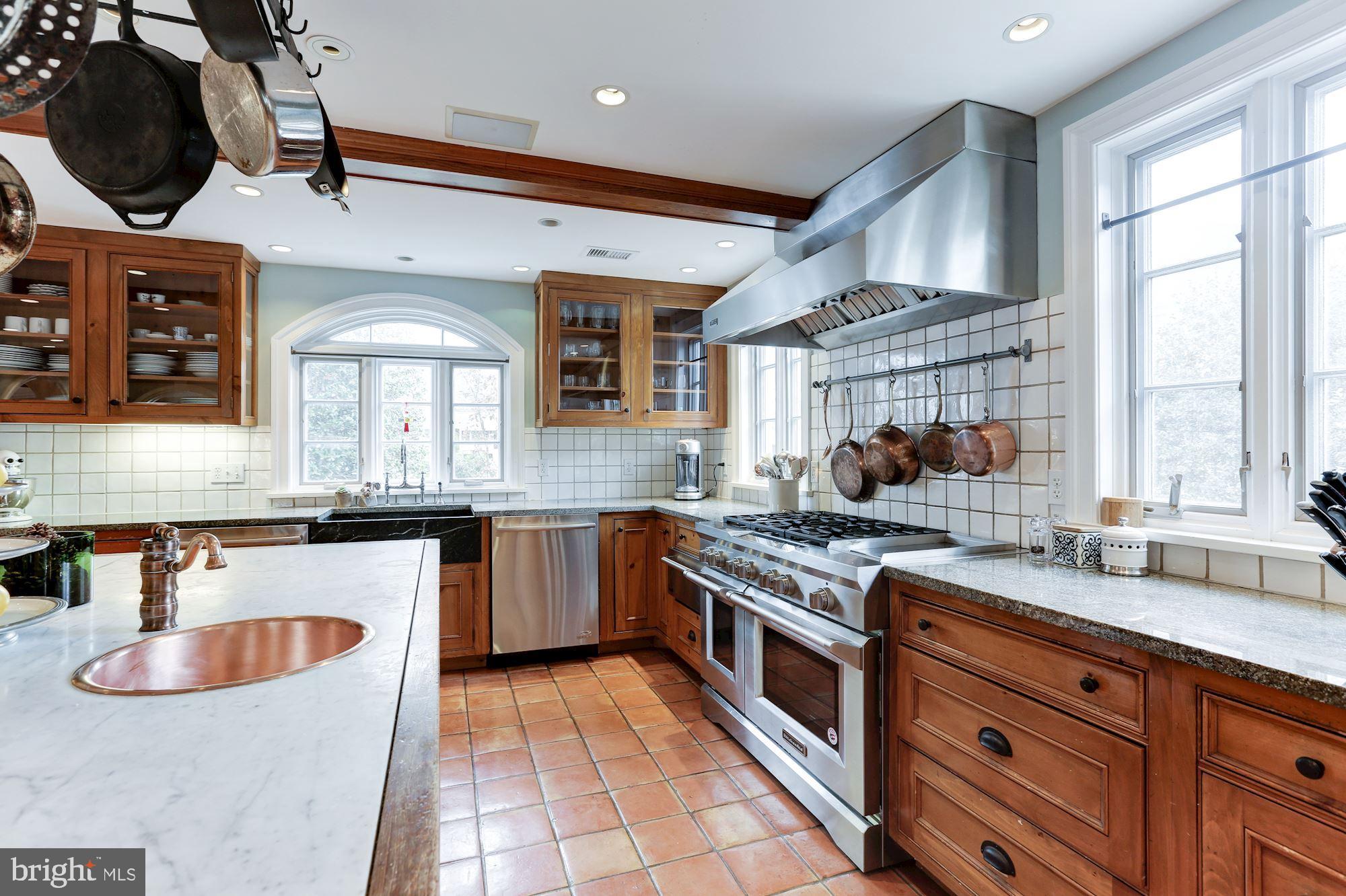 1319 Calder Road McLean, VA 22101 - Photo 13 of 55 a kitchen with stainless steel appliances granite countertop a stove a sink and a microwave