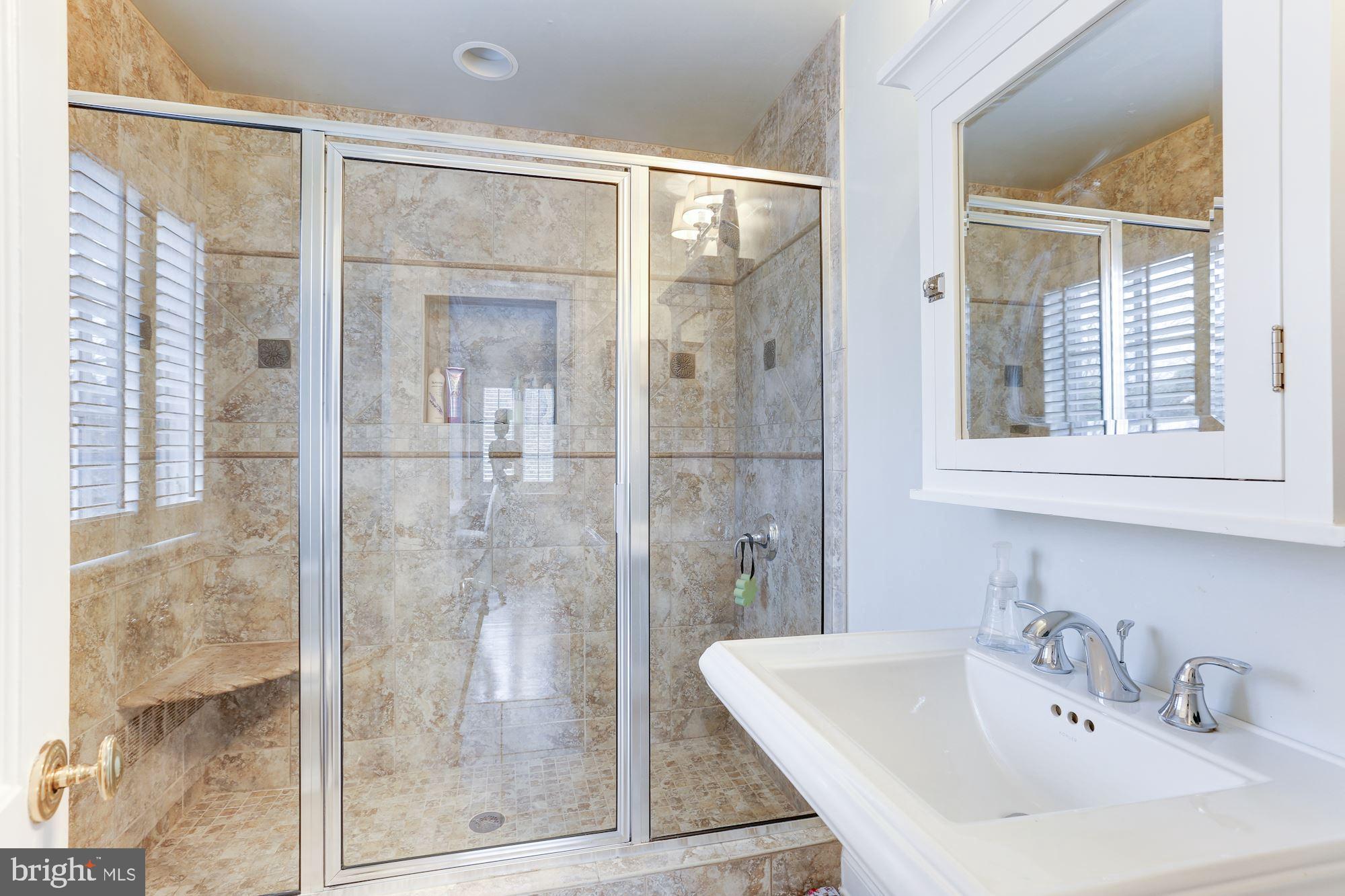 1319 Calder Road McLean, VA 22101 - Photo 33 of 55 a bathroom with a shower sink and mirror