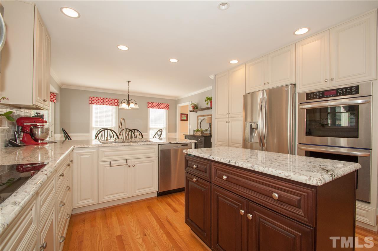 2012 Corberrie Lane Raleigh, NC 27613 - Photo 1 of 25 a kitchen with stainless steel appliances granite countertop a sink stove and refrigerator