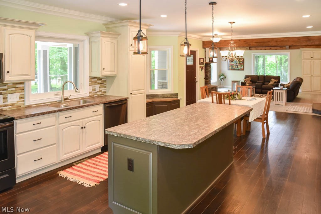 9410 Leroy Road Seville, OH 44273 - Photo 5 of 25 The kitchen has a center island with a breakfast bar and a pantry with pull out drawers.