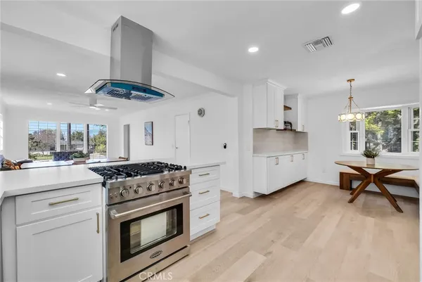 a kitchen with a stove a sink and a refrigerator