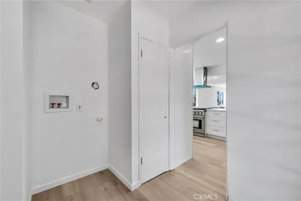 a view of kitchen with refrigerator cabinets and wooden floor