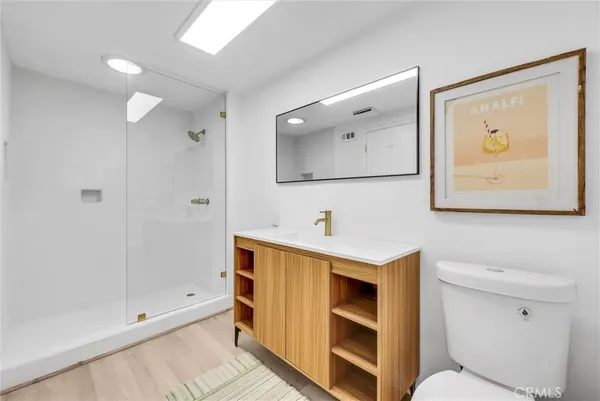 a bathroom with a sink mirror vanity and toilet