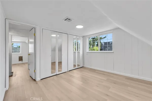 an empty room with windows and closet