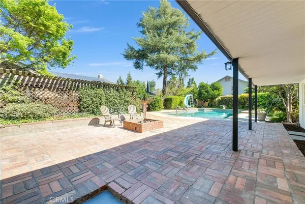 a view of a patio with a table and chairs