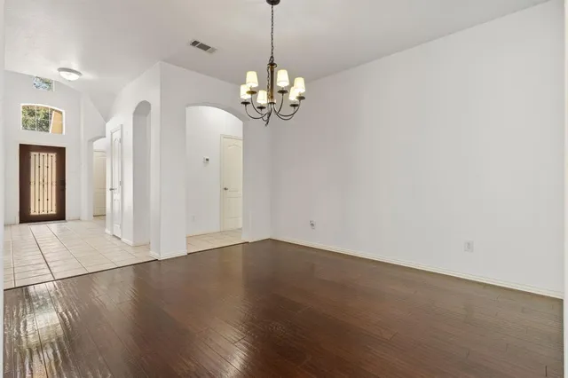 a view of kitchen with granite countertop cabinets and wooden floor