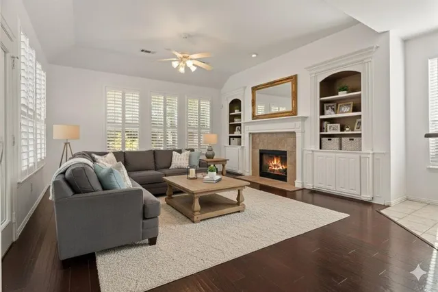 a living room with furniture fireplace and window