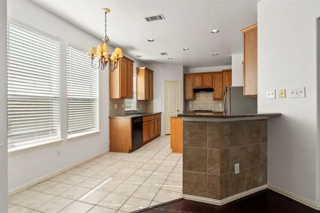 a kitchen with granite countertop a sink and a stove top oven