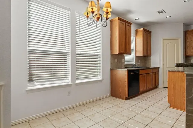 a kitchen with stainless steel appliances granite countertop a stove a sink and a window